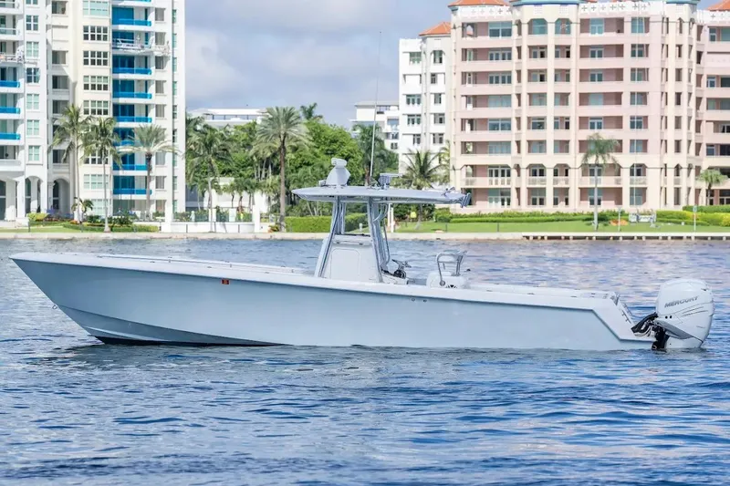 Slide: The Image of 2013 Contender 35 ST boat on water, with modern buildings in the background. - 19