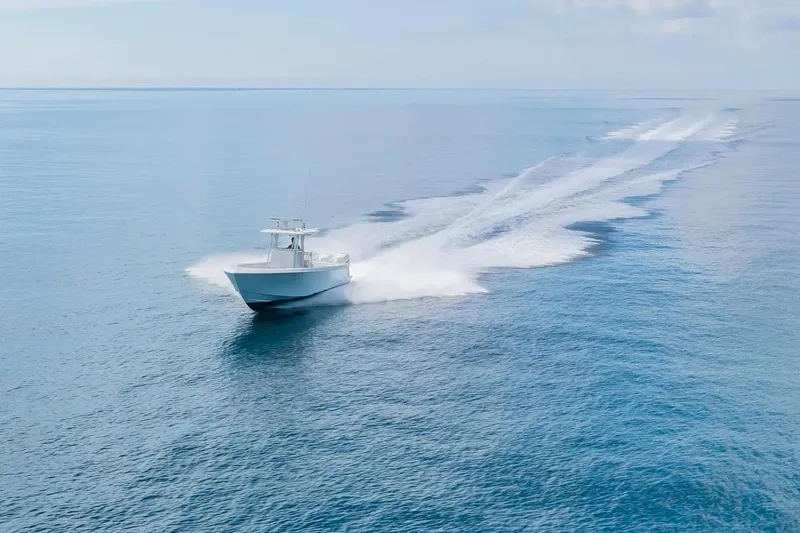 Slide: The Image of 2013 Contender 35 ST boat cruising on open blue ocean waters. - 20