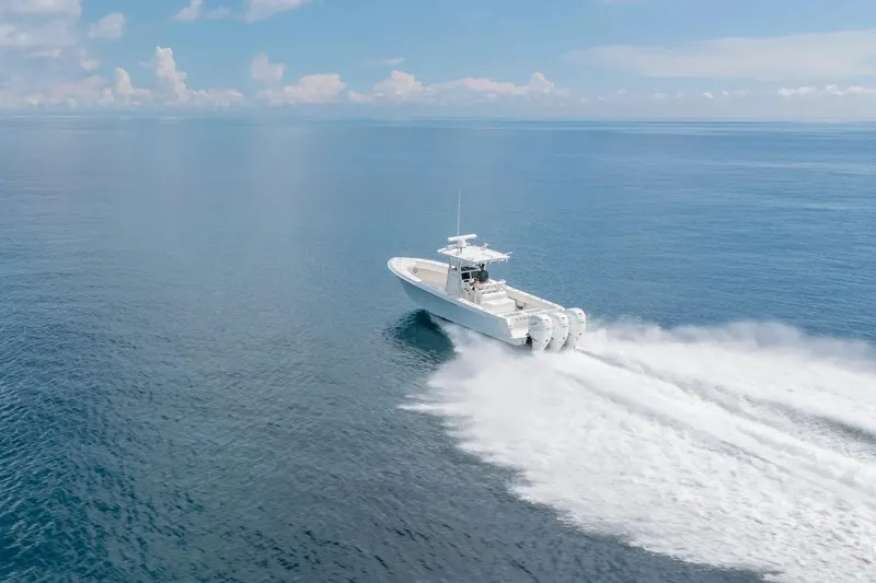 Slide: The Image of 2013 Contender 35 ST boat speeding on open ocean under clear blue sky. - 3
