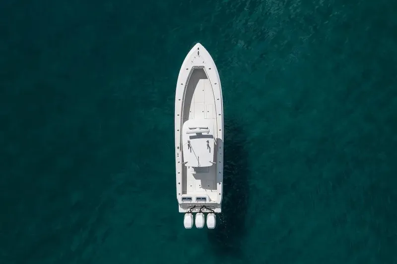Slide: The Image of Aerial view of 2013 Contender 35 ST boat on clear blue water. - 4