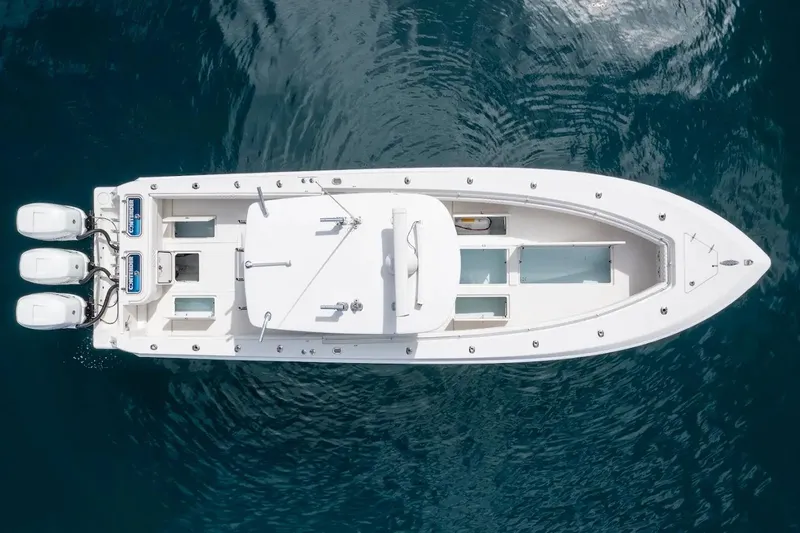 Slide: The Image of Aerial view of 2013 Contender 35 ST boat with triple outboard engines on blue water. - 5