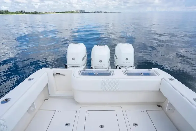 Slide: The Image of 2013 Contender 35 ST boat with triple engines on calm water. - 7