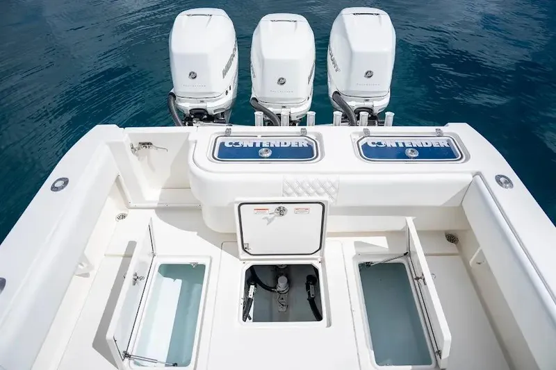 Slide: The Image of 2013 Contender 35 ST boat with triple outboard engines and open storage compartments. - 8