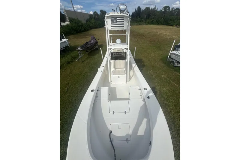 Slide: The Image of 2021 Panga Captiva boat on grass, showcasing spacious deck and elevated helm. - 10