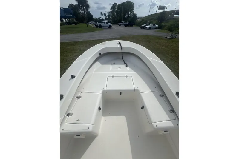 Slide: The Image of 2021 Panga Captiva boat interior with storage compartments, parked outdoors. - 11