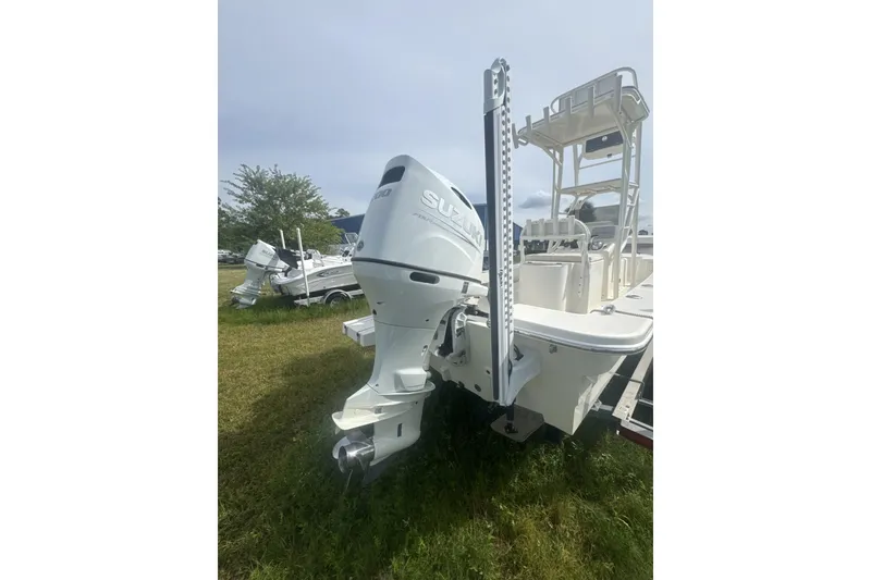 Slide: The Image of 2021 Panga Captiva boat with Suzuki outboard motor on grassy field. - 5