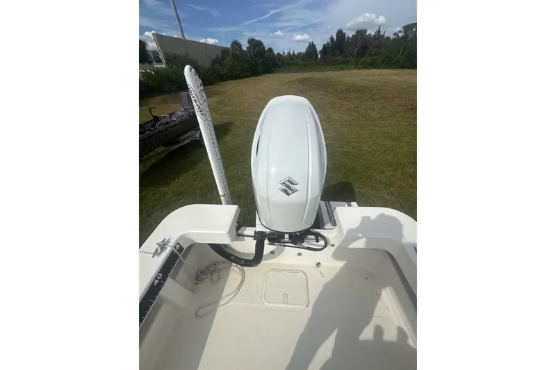 Slide: The Image of 2021 Panga Captiva boat with Suzuki outboard motor on grassy field. - 6