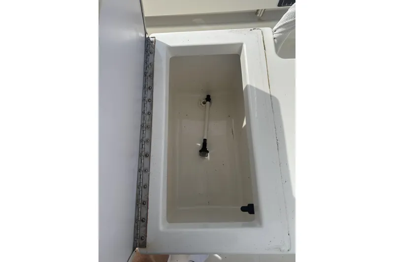 Slide: The Image of Open storage compartment on a 2021 Panga Captiva boat, featuring a clean, white interior. - 9
