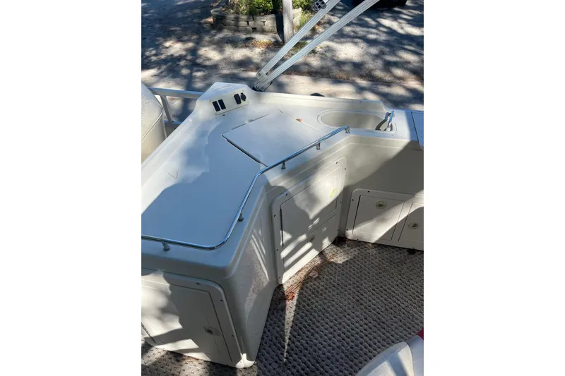 Slide: The Image of Interior view of 2026 Bennington 2575 RLX boat with kitchenette and storage cabinets. - 10