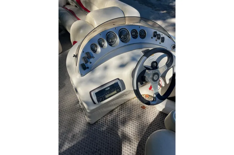 Slide: The Image of 2026 Bennington 2575 RLX boat dashboard with steering wheel and instrument panel. - 12