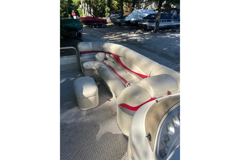 Slide: The Image of 2026 Bennington 2575 RLX boat interior with beige seating and red accents. - 15