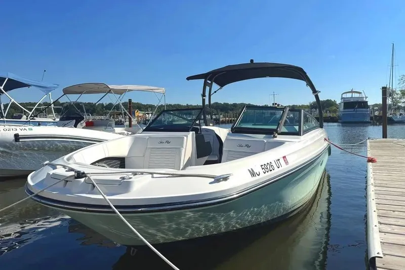 The Image of 2022 Sea Ray SPX 230 Outboard boat docked at marina under clear blue sky. - 0