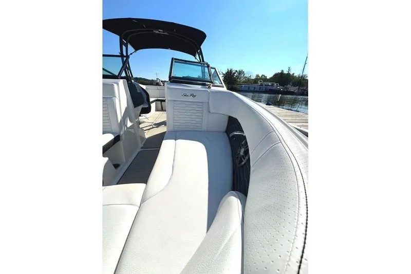 Slide: The Image of 2022 Sea Ray SPX 230 Outboard boat interior with white seating and black canopy. - 11