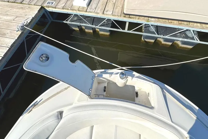 Slide: The Image of 2022 Sea Ray SPX 230 Outboard boat docked, open storage compartment visible. - 12