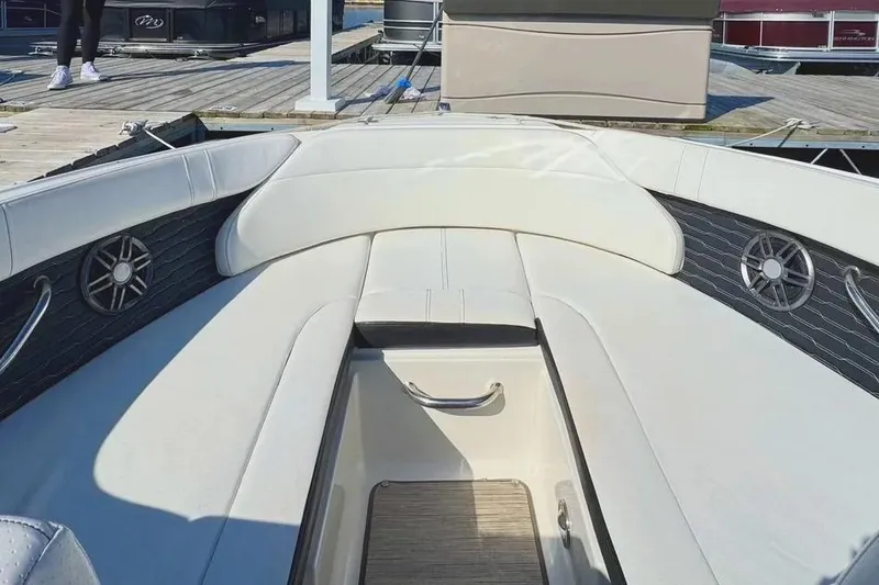 Slide: The Image of 2022 Sea Ray SPX 230 Outboard boat interior with white seating and speakers. - 13