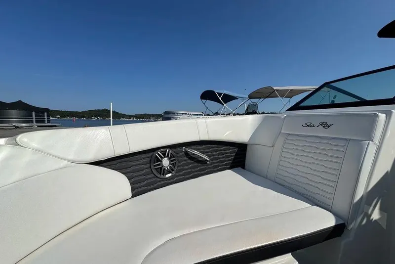 Slide: The Image of 2022 Sea Ray SPX 230 Outboard boat interior with white seating and scenic lake view. - 17
