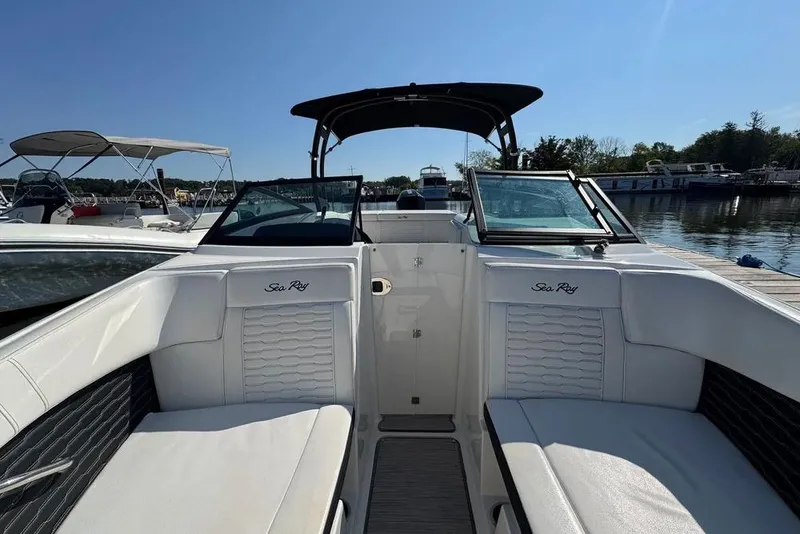 Slide: The Image of 2022 Sea Ray SPX 230 Outboard boat interior with white seating and open deck view. - 2