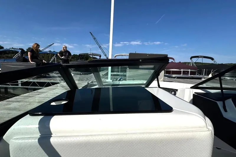 Slide: The Image of 2022 Sea Ray SPX 230 Outboard boat docked, with people enjoying the sunny day. - 24