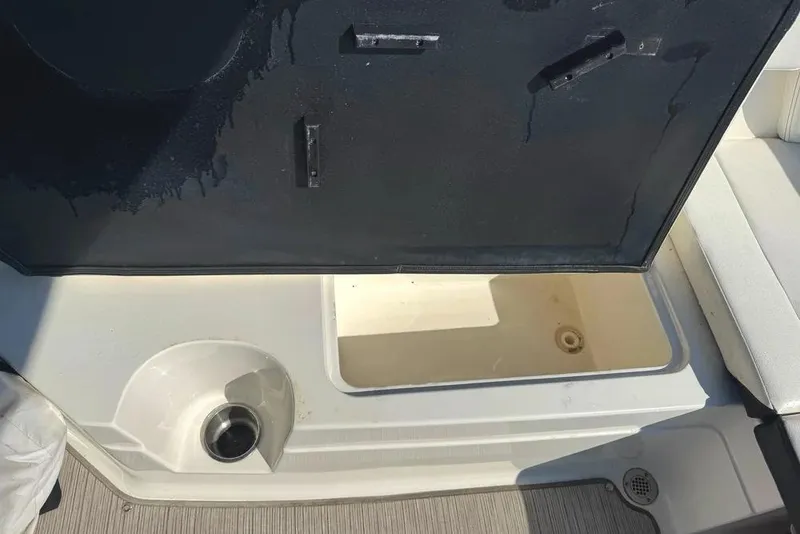 Slide: The Image of 2022 Sea Ray SPX 230 Outboard boat storage compartment with open lid. - 27