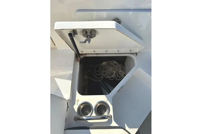 Slide: The Image of 2022 Sea Ray SPX 230 Outboard boat storage compartment with rope inside. - 29