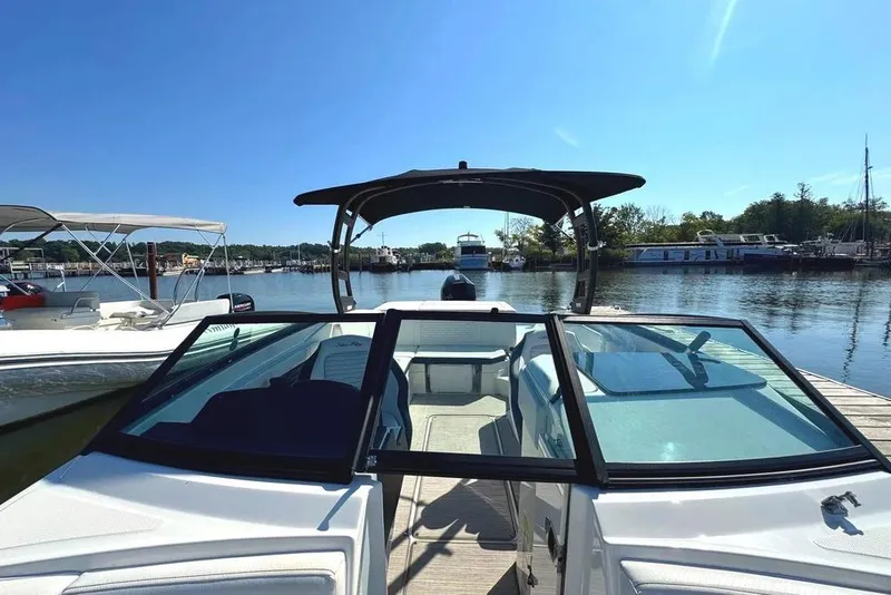 Slide: The Image of 2022 Sea Ray SPX 230 Outboard boat docked at a marina under clear blue skies. - 3