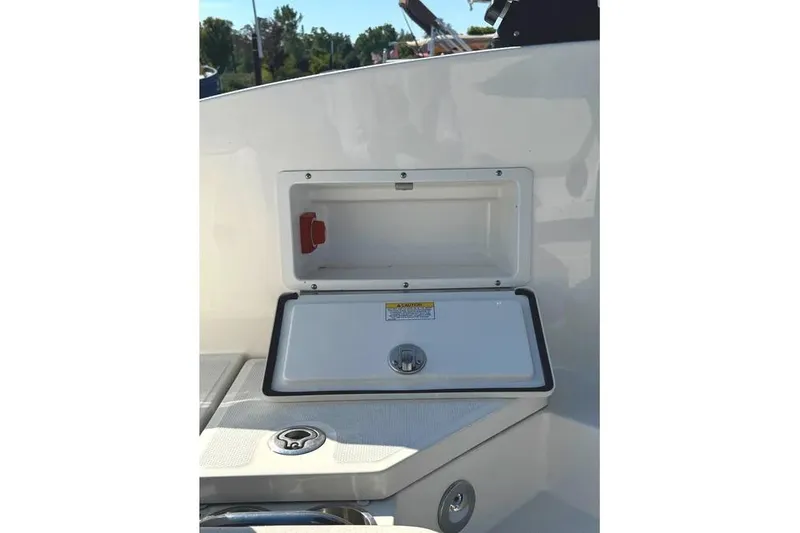 Slide: The Image of 2022 Sea Ray SPX 230 Outboard storage compartment with open hatch, showcasing interior space. - 30