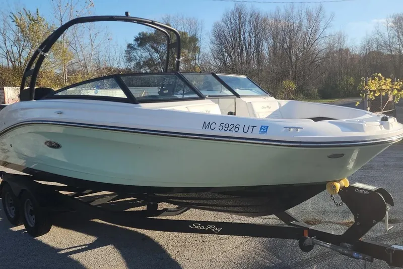 Slide: The Image of 2022 Sea Ray SPX 230 Outboard boat on trailer, parked outdoors. - 36