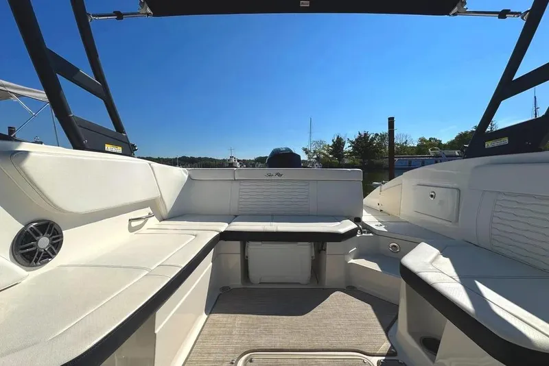 Slide: The Image of 2022 Sea Ray SPX 230 Outboard boat interior with white seating and open deck. - 4