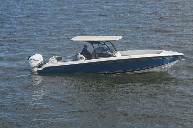 The Image of 2018 Nor-Tech 340 Sport Center Console boat cruising on open water. - 0