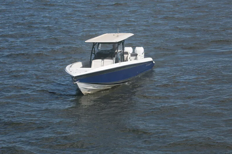 Slide: The Image of 2018 Nor-Tech 340 Sport Center Console boat on open water. - 10