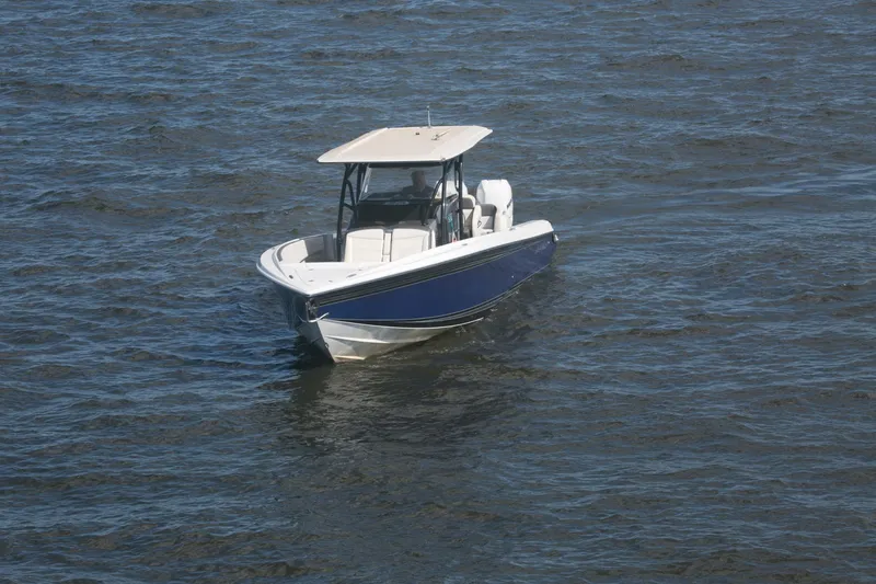 Slide: The Image of 2018 Nor-Tech 340 Sport Center Console boat on open water. - 11