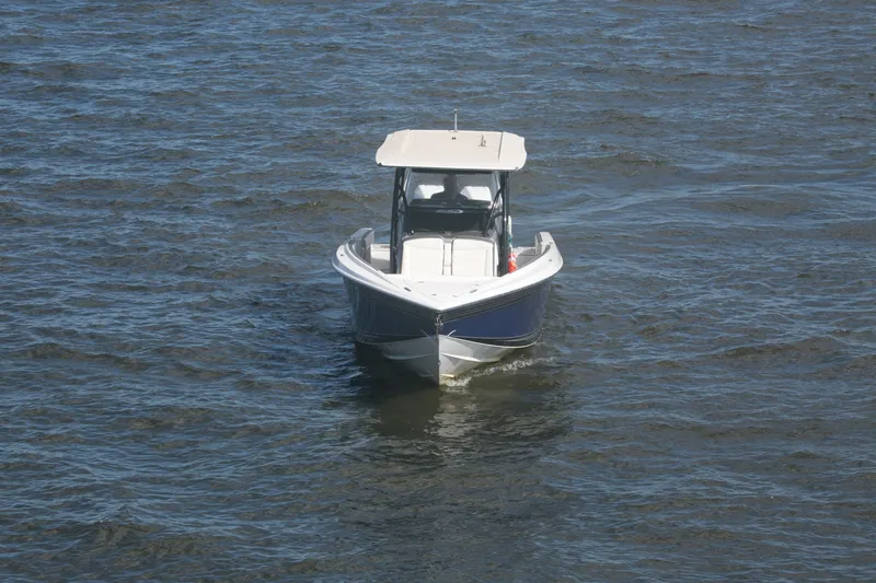 Slide: The Image of 2018 Nor-Tech 340 Sport Center Console boat on open water. - 12