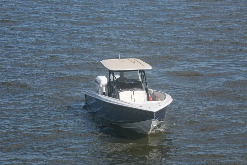 Slide: The Image of 2018 Nor-Tech 340 Sport Center Console boat cruising on open water. - 13