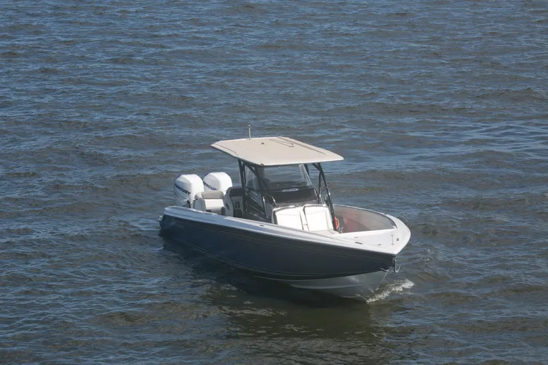 Slide: The Image of 2018 Nor-Tech 340 Sport Center Console boat cruising on open water. - 14