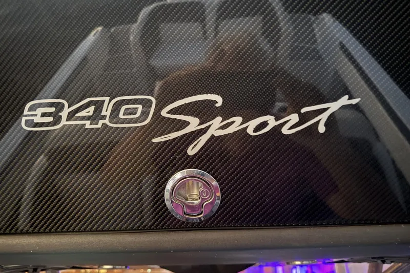 Slide: The Image of 2018 Nor-Tech 340 Sport Center Console logo on carbon fiber surface. - 16