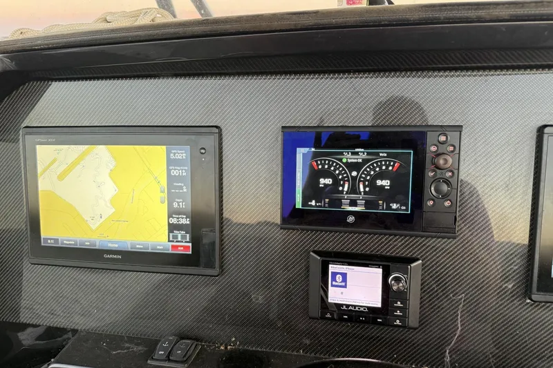 Slide: The Image of Dashboard of 2018 Nor-Tech 340 Sport Center Console with navigation and audio displays. - 17