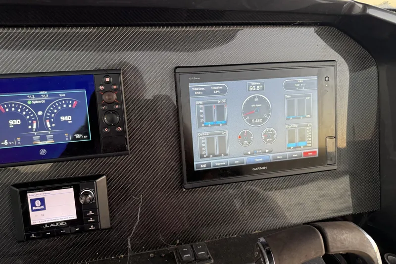Slide: The Image of Dashboard of a 2018 Nor-Tech 340 Sport Center Console with Garmin navigation display. - 18