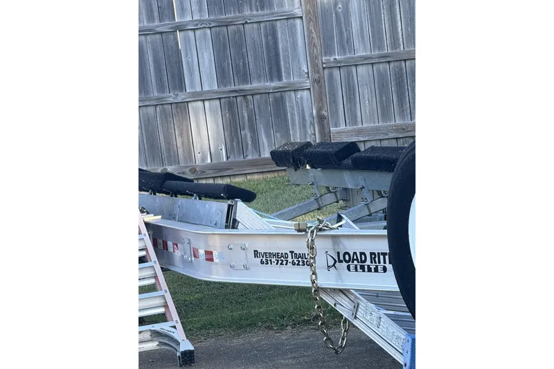 Slide: The Image of Trailer for 2018 Nor-Tech 340 Sport Center Console near wooden fence. - 22