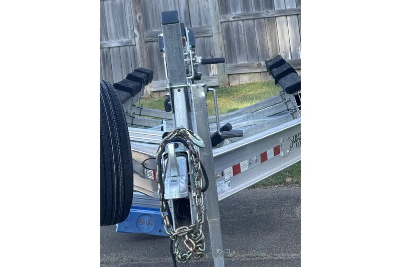 Slide: The Image of Trailer for 2018 Nor-Tech 340 Sport Center Console, parked on pavement near wooden fence. - 23