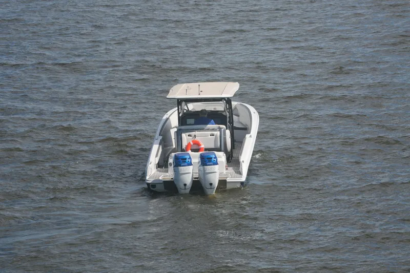Slide: The Image of 2018 Nor-Tech 340 Sport Center Console boat on open water, rear view. - 3