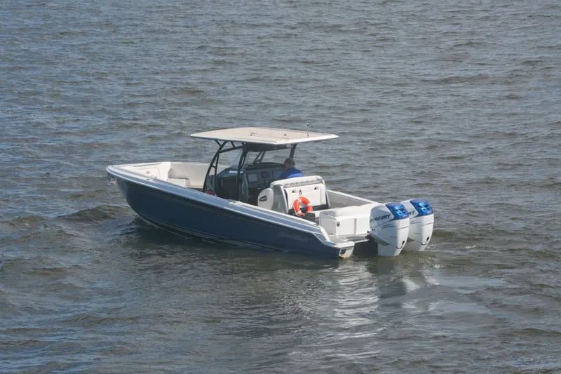 Slide: The Image of 2018 Nor-Tech 340 Sport Center Console boat on water with dual Mercury engines. - 6