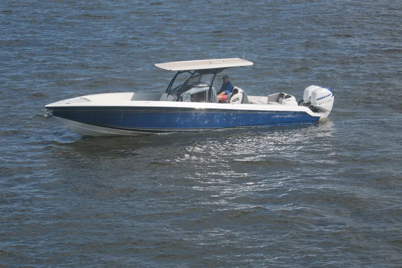 Slide: The Image of 2018 Nor-Tech 340 Sport Center Console boat cruising on open water. - 8