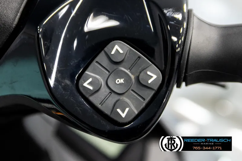 Slide: The Image of Close-up of 2024 Sea Doo 170 Wake GTI handlebar controls with directional buttons. - 18