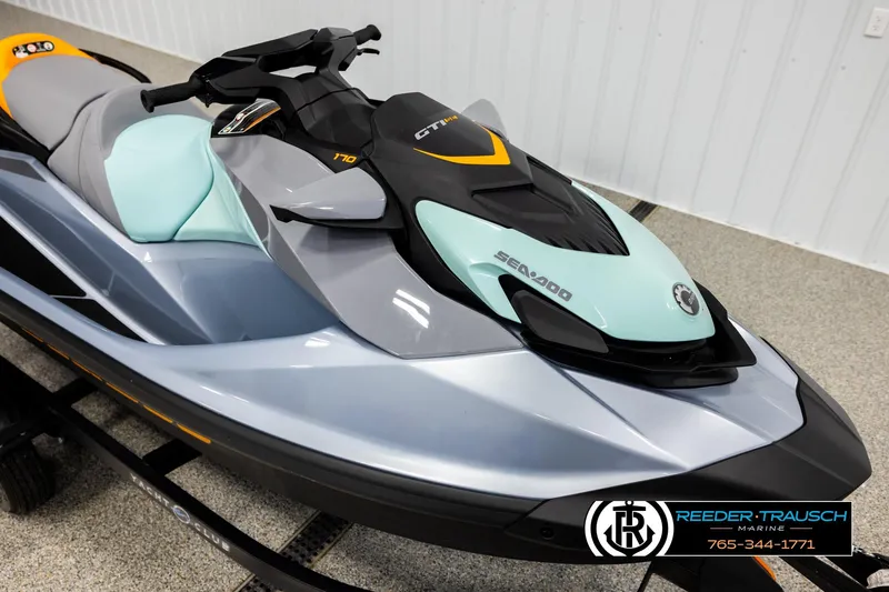 Slide: The Image of 2024 Sea Doo 170 Wake GTI jet ski in showroom, featuring sleek design and vibrant colors. - 7