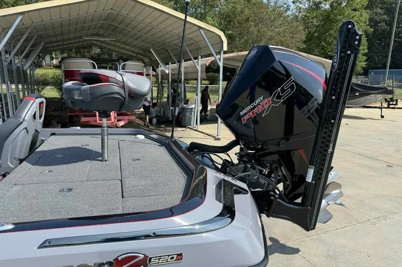 Slide: The Image of 2023 Ranger Z520R 55th Anniversary boat with Mercury Pro XS engine, docked under a canopy. - 7