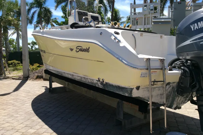 The Image of 2005 Seaswirl Striper 2101 Center Console boat on a stand, with Yamaha outboard motor. - 1