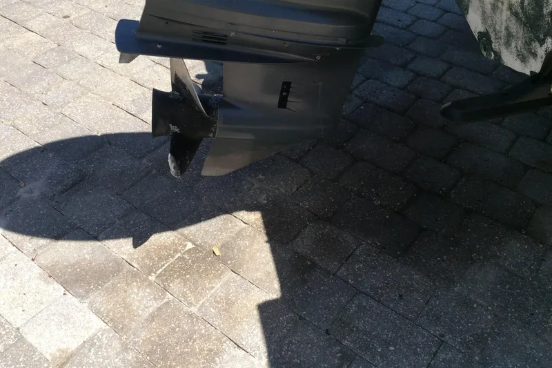 Slide: The Image of 2005 Seaswirl Striper 2101 Center Console outboard motor on paved surface. - 12