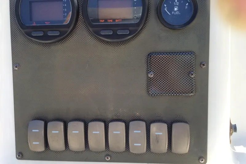Slide: The Image of Dashboard of 2005 Seaswirl Striper 2101 Center Console O/B with gauges and switches. - 3