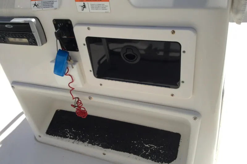 Slide: The Image of 2005 Seaswirl Striper 2101 Center Console dashboard with controls and storage compartment. - 5