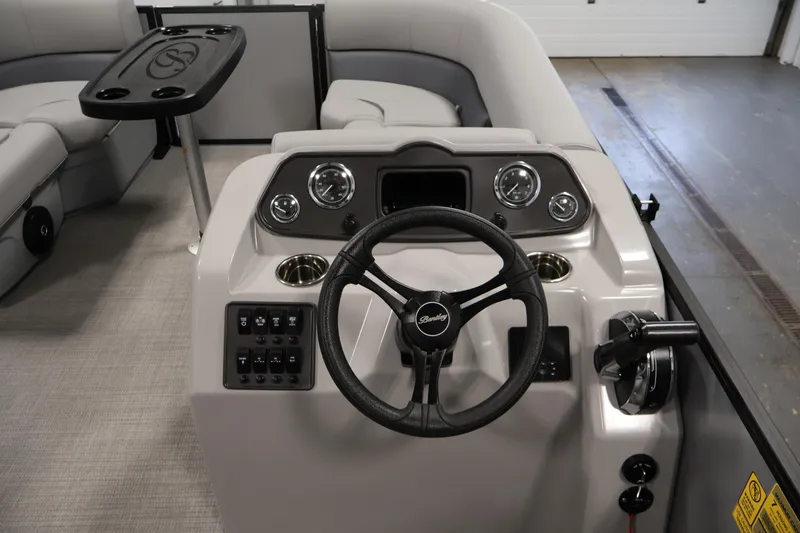 Slide: The Image of 2026 Bentley Pontoons 160 Cruise LE dashboard with steering wheel and controls. - 18